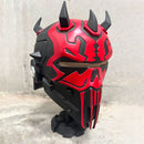 Red and black Darth Maul concept helmet with spikes on a textured surface
